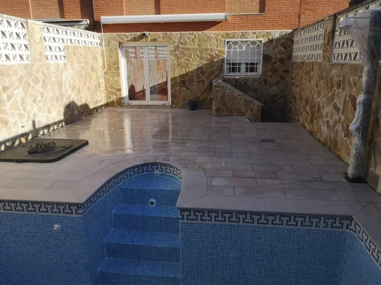 patio con piscina y escalera de caracol